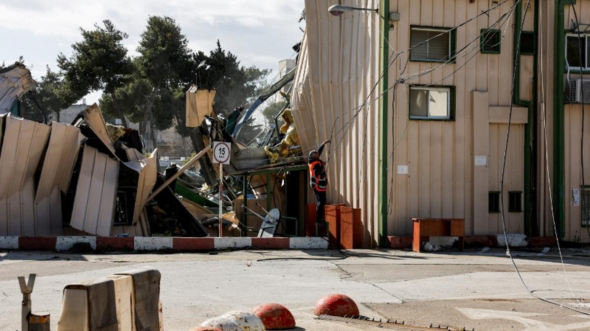 FILE PHOTO: A man handles fallen cables at the Jerusalem headquarters of the United Nations Relief and Works Agency for Palestine Refugees (UNRWA) as the headquarters is dismantled by Israeli forces, in East Jerusalem, January 20, 2026. REUTERS/Ammar Awad/File Photo