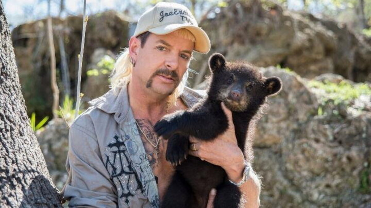 Convicted felon Joe Exotic with a baby bear. (JoeExoticTV via SWNS). 
