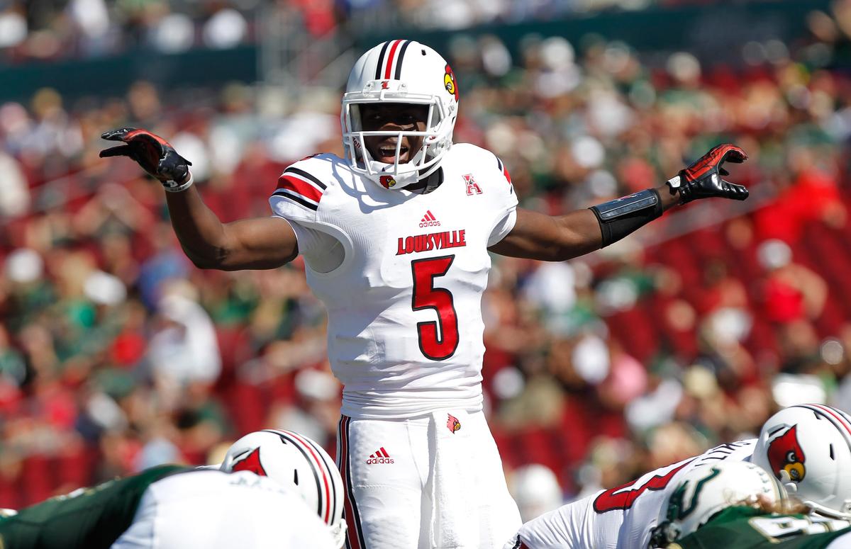 Oct 26, 2013; Tampa, FL, USA; Louisville Cardinals quarterback Teddy Bridgewater (5) calls a play against the South Florida Bulls during the first half at Raymond James Stadium. Mandatory Credit: Kim Klement-USA TODAY Sports