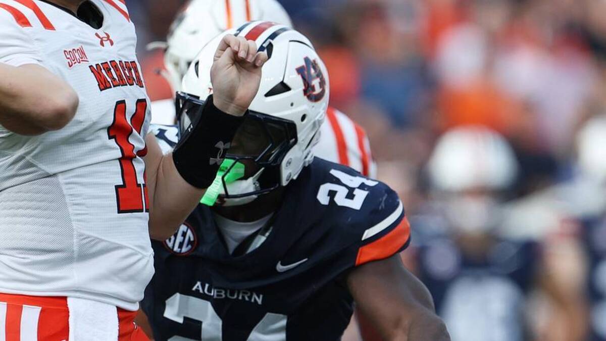  Nov 22, 2025; Auburn, Alabama, USA; Mercer Bears quarterback Braden Atkinson (11) throws a pass as Auburn Tigers defensive end Keyron Crawford (24) closes in during the second quarter at Jordan-Hare Stadium. Mandatory Credit: John Reed-Imagn Images | John Reed-Imagn Images 