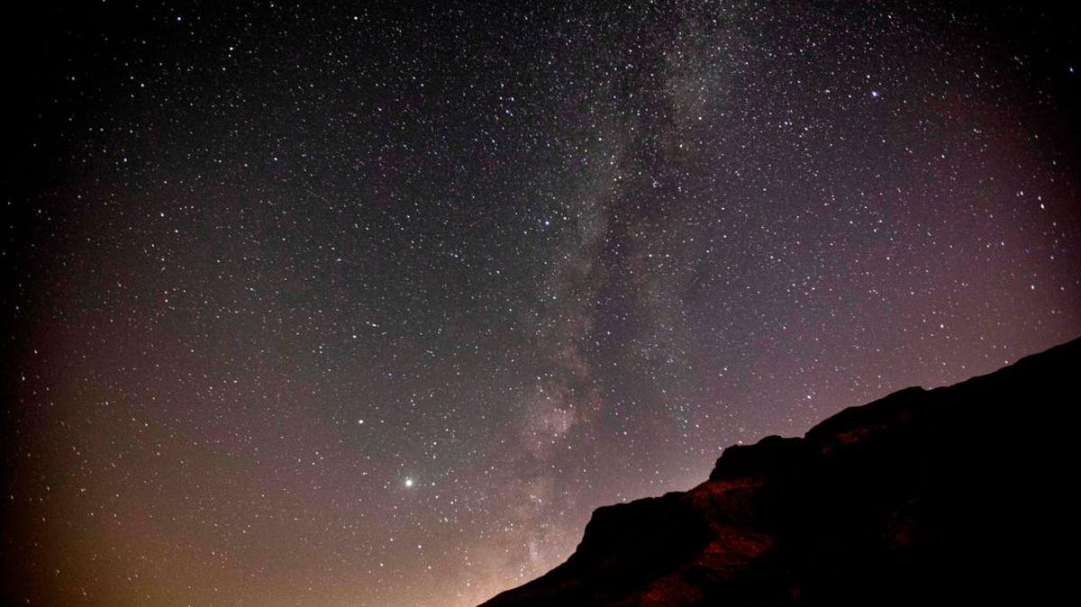 This long-exposure picture taken early on August 20, 2020 shows a view of the Milky Way galaxy rising in the sky above the Judaean mountains in the occupied West Bank between Palestinian Jericho and Israel's Ein Gedi. (Photo by AHMAD GHARABLI / AFP) (Photo by AHMAD GHARABLI/AFP via Getty Images)