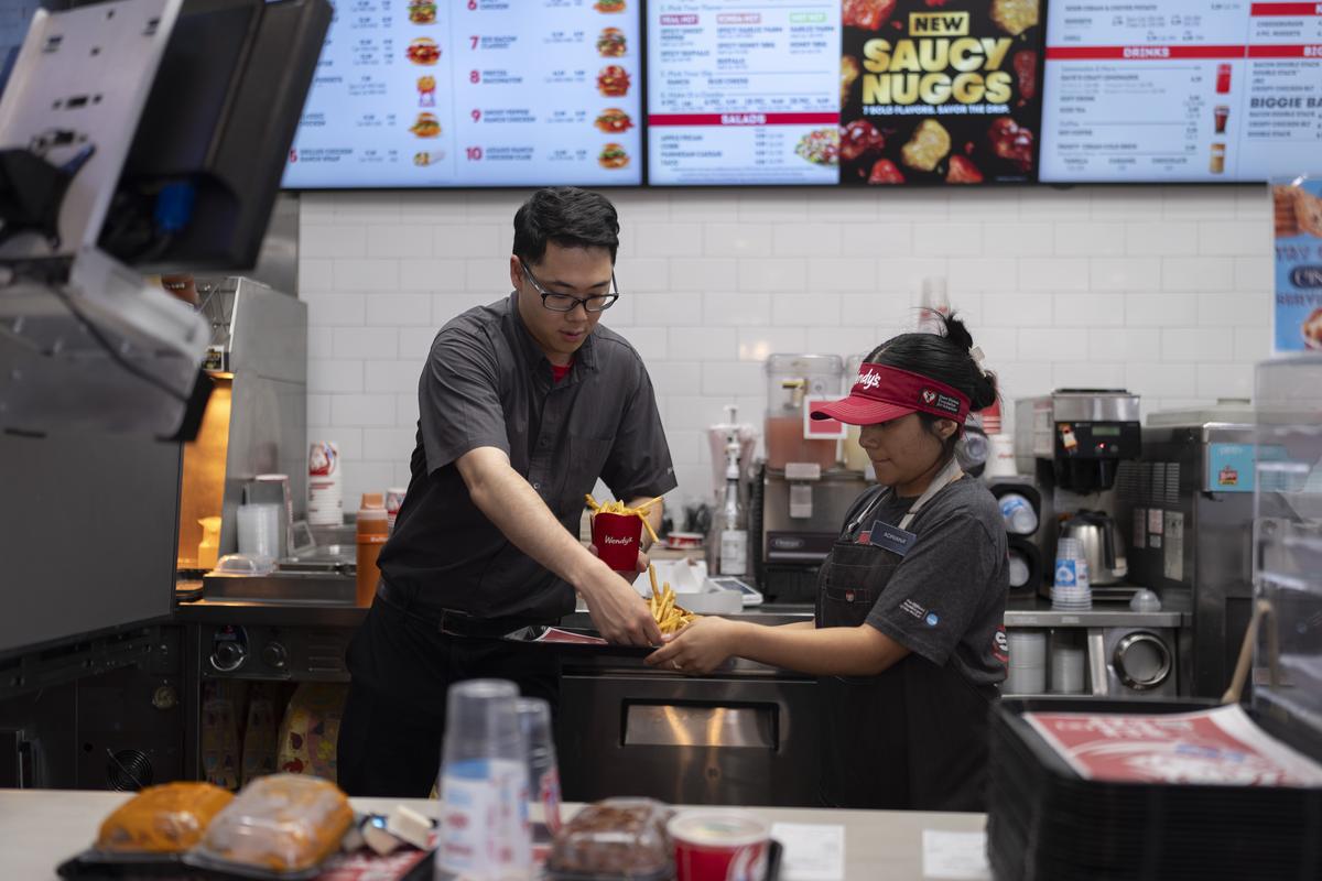  File: Workers prepare a meal at a Wendy’s restaurant in Fountain Valley, California, on June 20, 2024. 