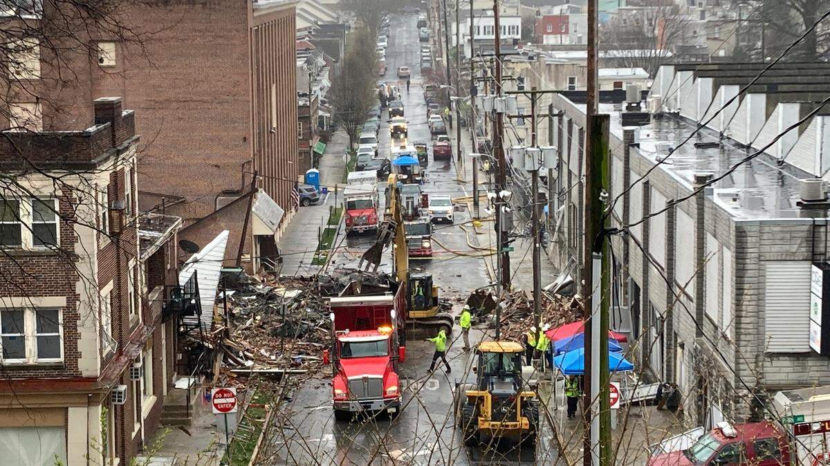 Emergency responders and heavy equipment are seen at the site of a deadly explosion at a chocolate factory in West Reading, Pennsylvania, Saturday, March 25. (AP Photo/Michael Rubinkam)