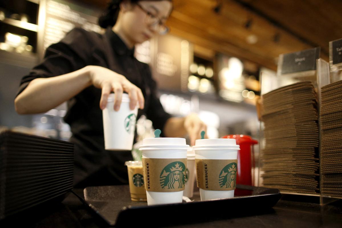 FILE PHOTO: A staff serves beverages at a Starbucks coffee shop in Seoul, South Korea, March 7, 2016. Picture taken March 7, 2016. REUTERS/Kim Hong-Ji/File Photo