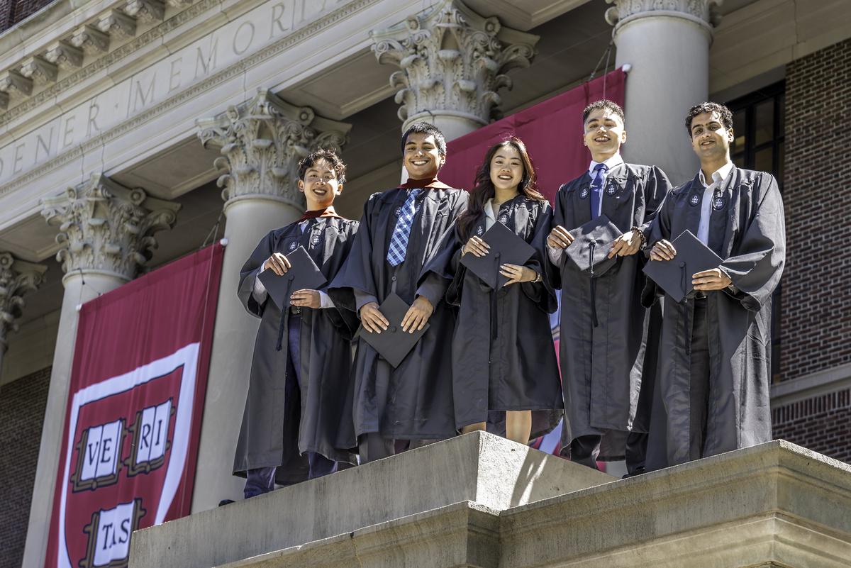  Five graduating students at Harvard University pose for a picture standing at the top of the parapet wall at Widener Library. (Photo by Steve Rosenbach/Getty Images) 