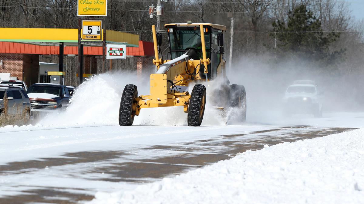 An MDOT snow plow clears off the snow, sleet and ice build up on Highway 178 in the Macedonia community of Lee County, Miss., Tuesday, Feb. 16, 2021.