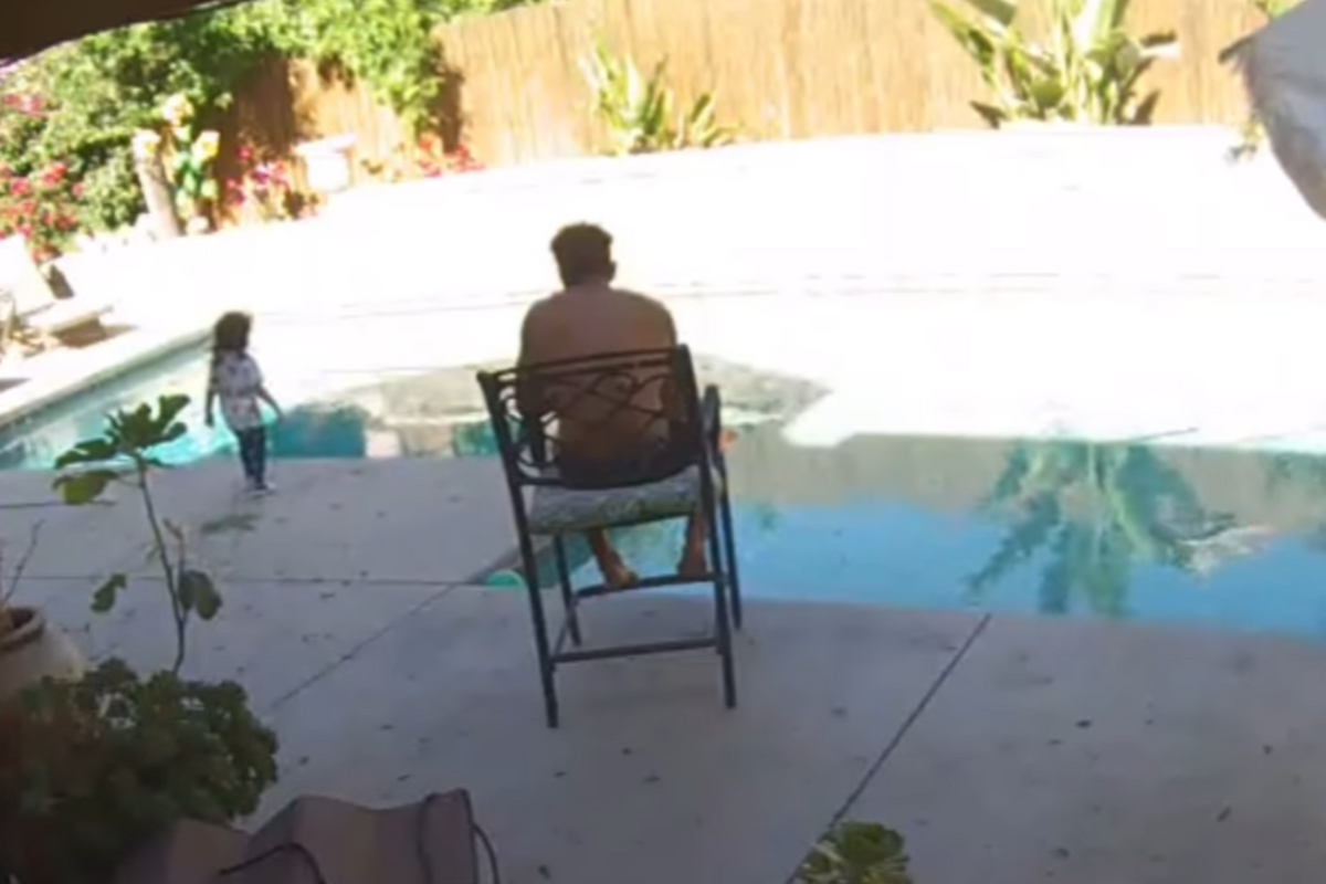  A still image from a home security camera shows Keoki Silva in his backyard as his toddler daughter, Aria, approaches the pool. 