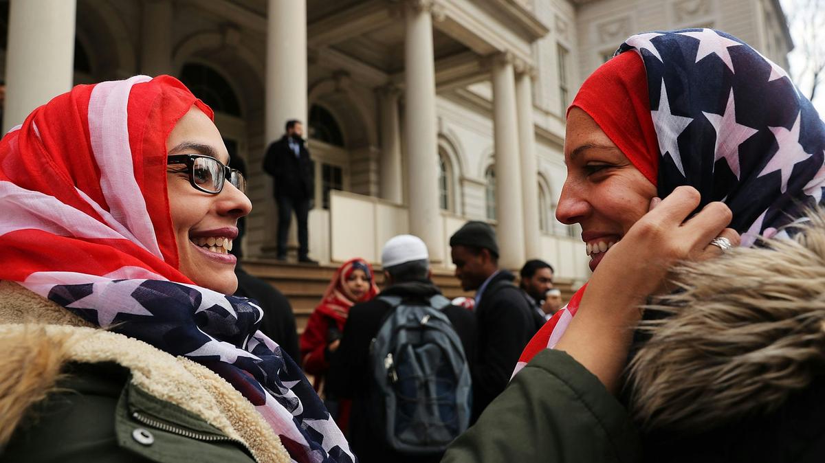 Two police officers wear American flag head scarfs at a World Hijab Day event on Feb. 1, 2017, in New York City.