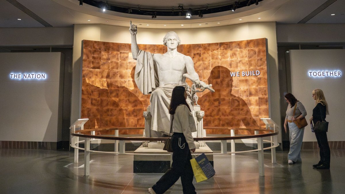People walk by a statue of George Washington by Horatio Greenough while visiting the Smithsonian National Museum of American History in 2025. The White House has released a report criticizing the museum for "extreme political activism." File Photo by Bonnie Cash/UPI