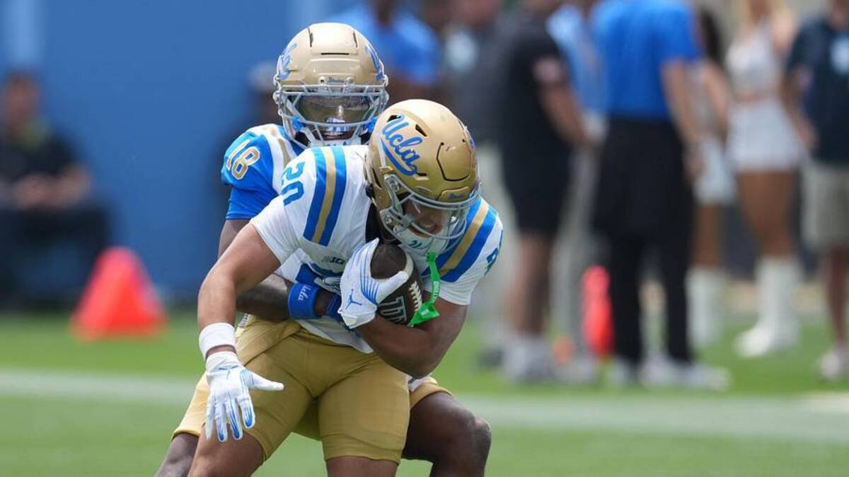  May 2, 2026; Pasadena, CA, USA; UCLA Bruins defensive back Osiris Gilbert (18) tackles receiver Shane Rosenthal (20) during the spring game at Rose Bowl. Mandatory Credit: Kirby Lee-Imagn Images | Kirby Lee-Imagn Images 