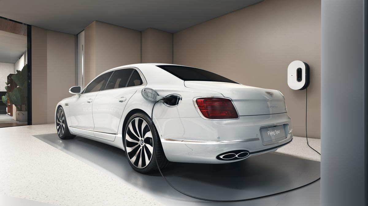  A car being charged inside a residence. 