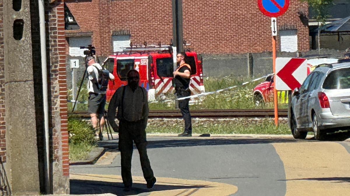 Emergency vehicles operate near the scene where a school bus was struck by a train at a level crossing leading to multiple casualities, near the town of Buggenhout, Belgium, May 26, 2026. REUTERS/Bart Biesemans