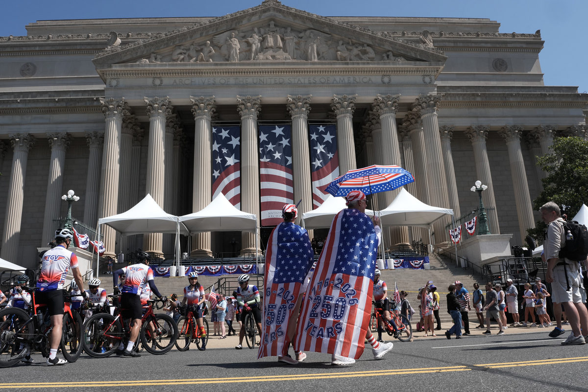 People stop outside the National Archives as they celebrate the 250th anniversary of the United States in Washington, July 4, 2026. America celebrates the 250th anniversary of its independence today, with people from one end of the country to the other marking the milestone with fireworks, parades and concerts. (Alex Kent/The New York Times)