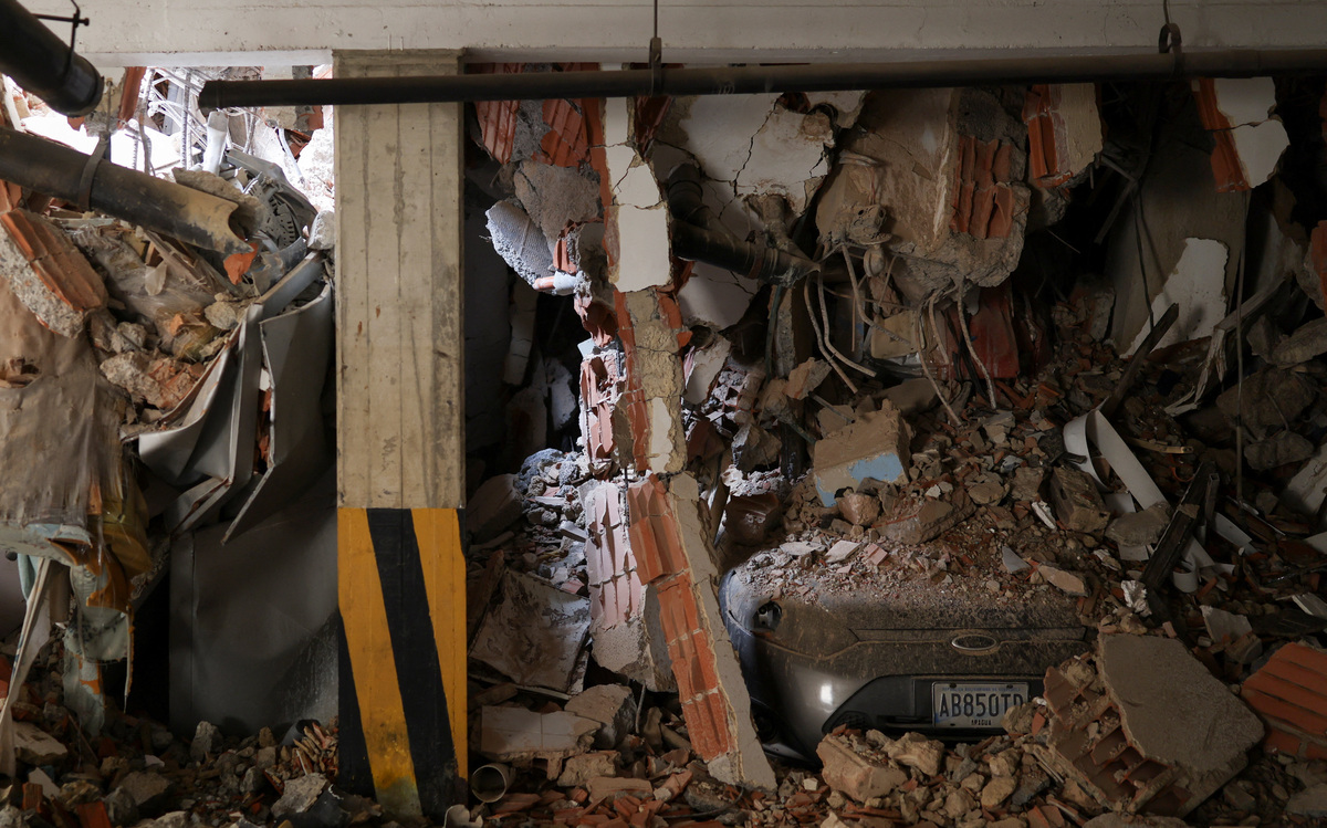 A car lies trapped in rubble in the aftermath of the June 24 earthquakes, in La Guaira, Venezuela, July 4, 2026. REUTERS/Pablo Sanhueza