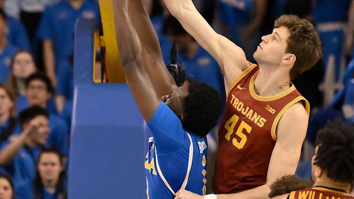  Feb 24, 2026; Los Angeles, California, USA; UCLA Bruins forward Xavier Booker (1) and Southern California Trojans center Gabe Dynes (45) battle for a rebound during the 2nd half at Pauley Pavilion presented by Wescom Financial. Mandatory Credit: Robert Hanashiro-Imagn Images | Robert Hanashiro-Imagn Images 