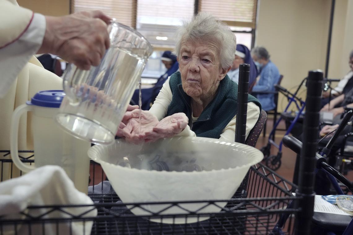 Water is poured over the hands of Sister Mary Kay Finneran during Maundy Thursday Mass at Kittay Senior Apartments in the Bronx borough of New York on April 6, 2026. An influential order of nuns decided to complete its mission when the last sister dies. The only question left is how to finish well. (Michelle V. Agins/The New York Times)