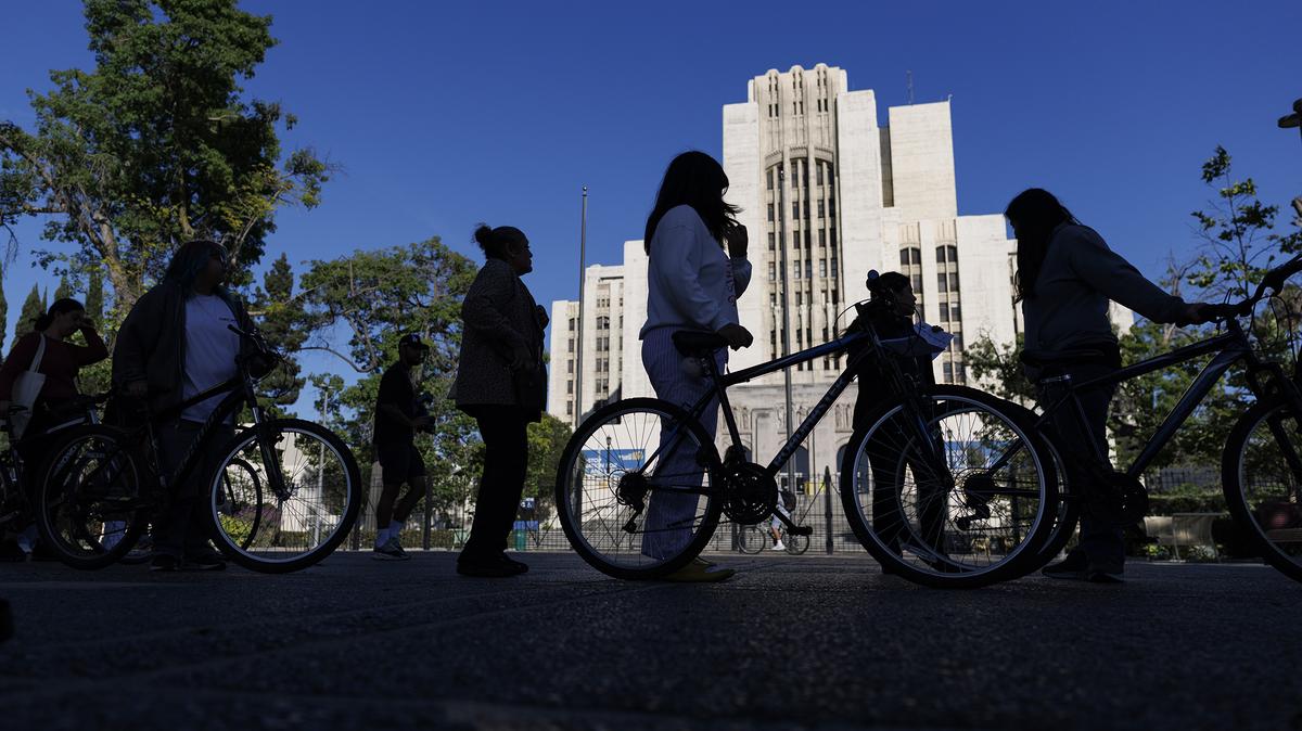 Los Angeles residents line up with a bike of their choice during a bike give-away event on the grounds of the Old General Hospital on April 22, 2026, in Los Angeles, California. Abandoned bicycles were stored for years in the basement of the old hospital and recently a local bike shop owner and his workers triage the bikes and brought them back to working condition. (Gina Ferazzi/Los Angeles Times/TNS)