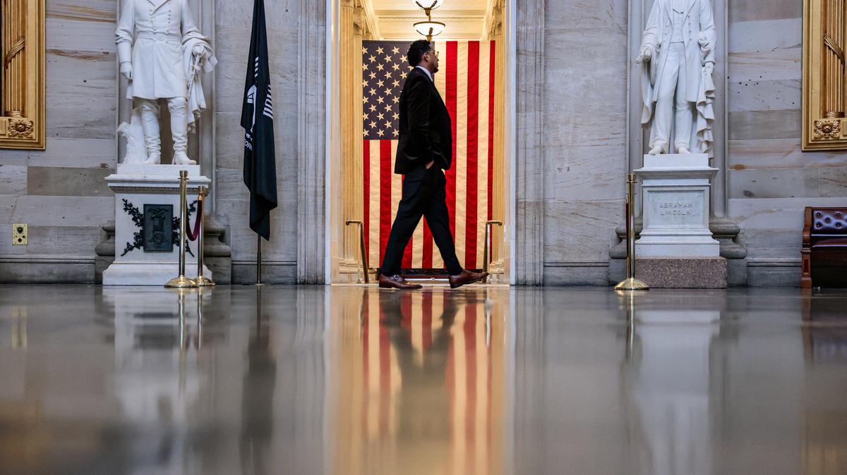 A person walks in front of an American flag in the Rotunda of the U.S. Capitol building in Washington, D.C., U.S., May 14, 2026. REUTERS/Kylie Cooper