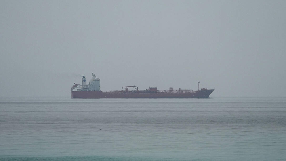 The oil tanker JORYA sails near the Omani coast, as seen from Musandam, Oman, on Thursday. The U.N. International Maritime Organization paused its operation to escort ships through the Strait of Hormuz on Thursday after a vessel reported an attack.
