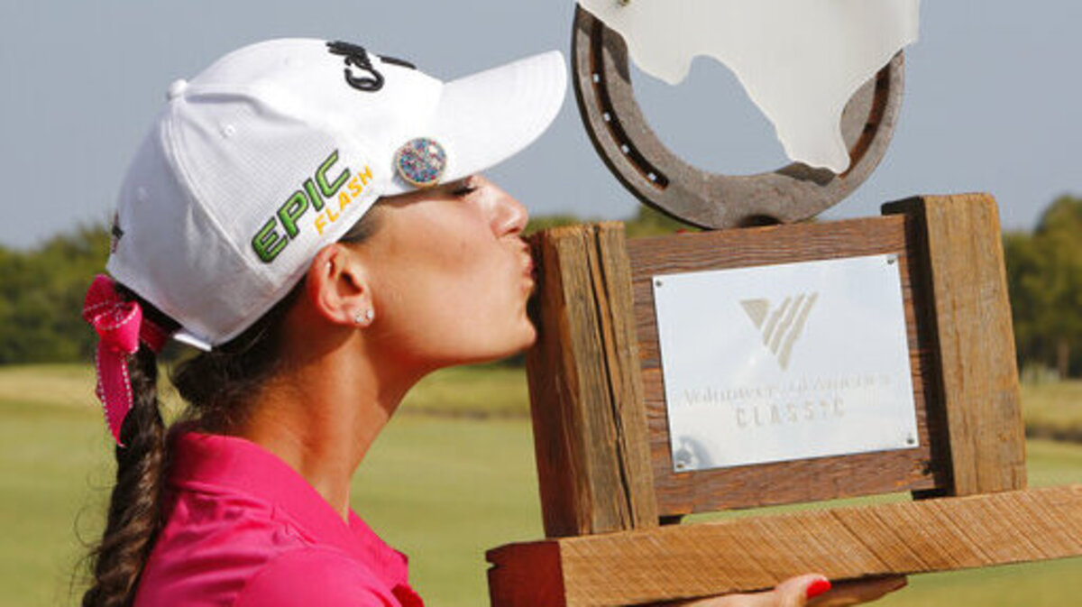 Cheyenne Knight, from Aledo, Texas, kisses the trophy after winning the LPGA Volunteers of America golf tournament Sunday, Oct. 6, 2019, at Old American Golf Club in The Colony, Texas.