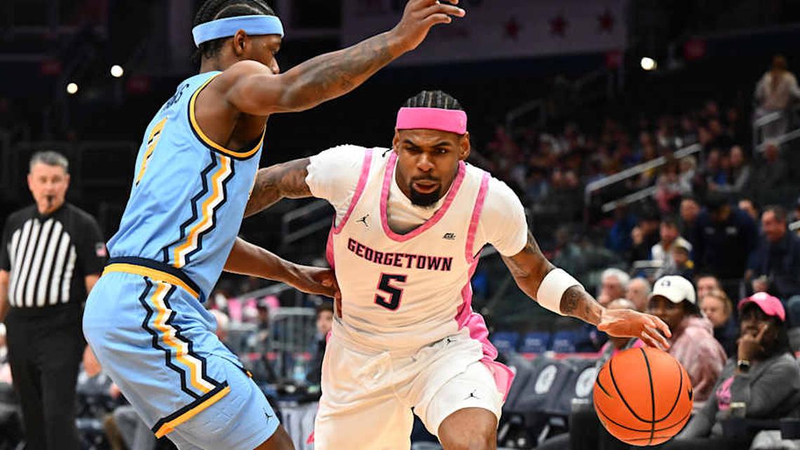  Feb 24, 2026; Washington, District of Columbia, USA; Georgetown Hoyas guard KJ Lewis (5) dribbles as Marquette Golden Eagles guard Chase Ross (2) defends during the first half at Capital One Arena. Mandatory Credit: Brad Mills-Imagn Images | Brad Mills-Imagn Images 