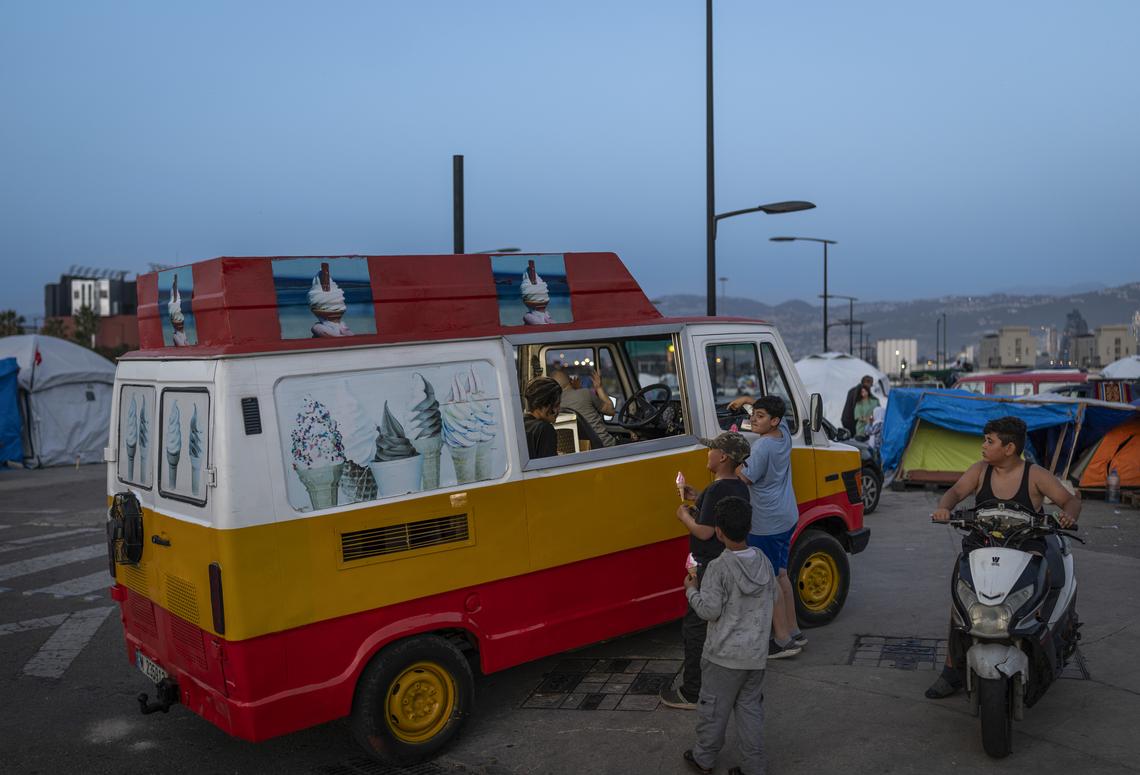Young internally displaced people buy ice cream from a van in Beirut, April 16, 2026. President Trump announced on Thursday that the leaders of Israel and Lebanon had agreed to begin a 10-day cease-fire at 5 p.m. Eastern time. (Diego Ibarra Sánchez/The New York Times)