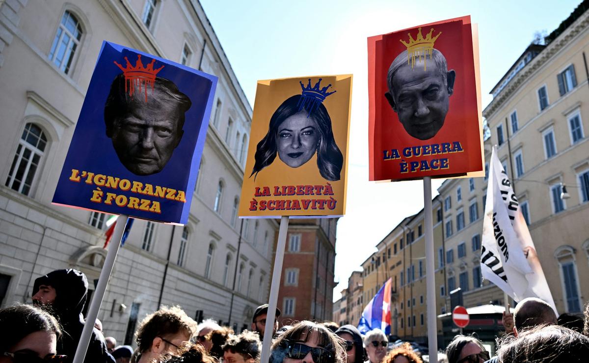  Protesters against the Iran war carry placards in Rome on March 28, 2026, depicting U.S. President Donald Trump, Italy's Prime Minister Giorgia Meloni and Israeli Prime Minister Benjamin Netanyahu. Tiziana Fabi/AFP via Getty Images 