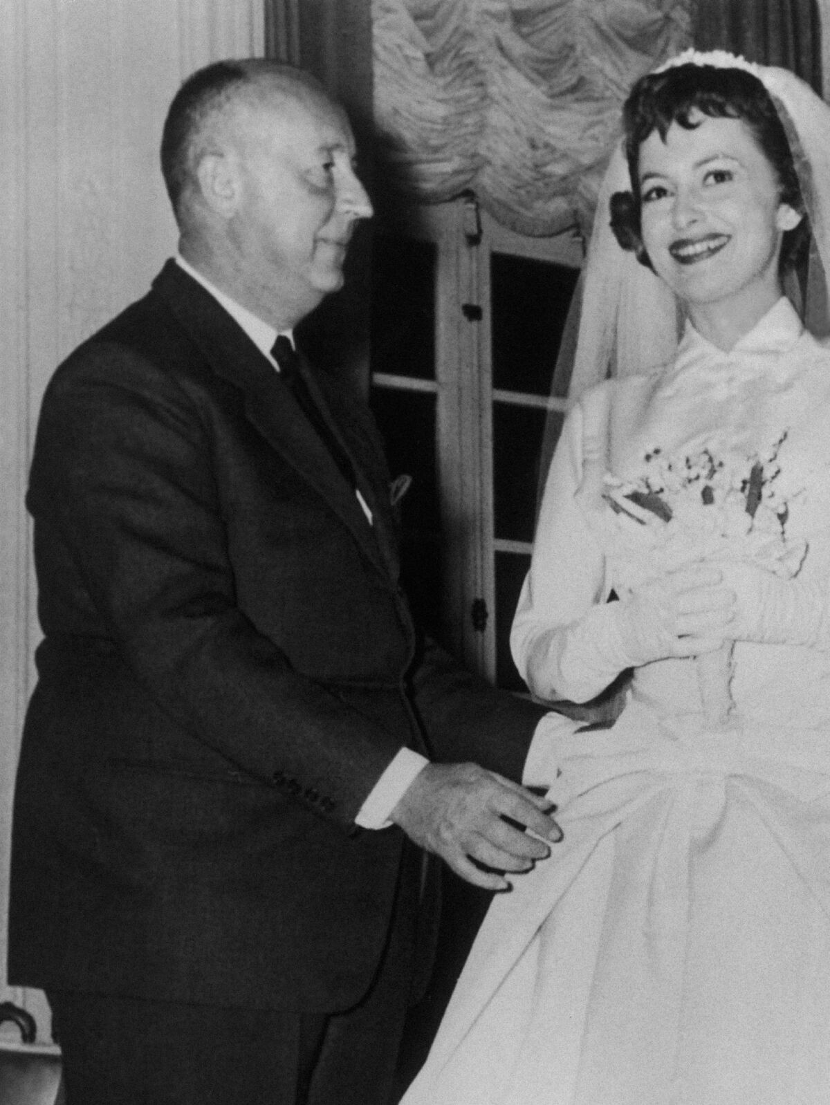 Olivia De Havilland wearing a Christian Dior wedding dress for the Film ‘La Fille De L’Ambassadeur’. The designer himself is seen making the last alterations.Keystone-France/Gamma-Keystone via Getty Images