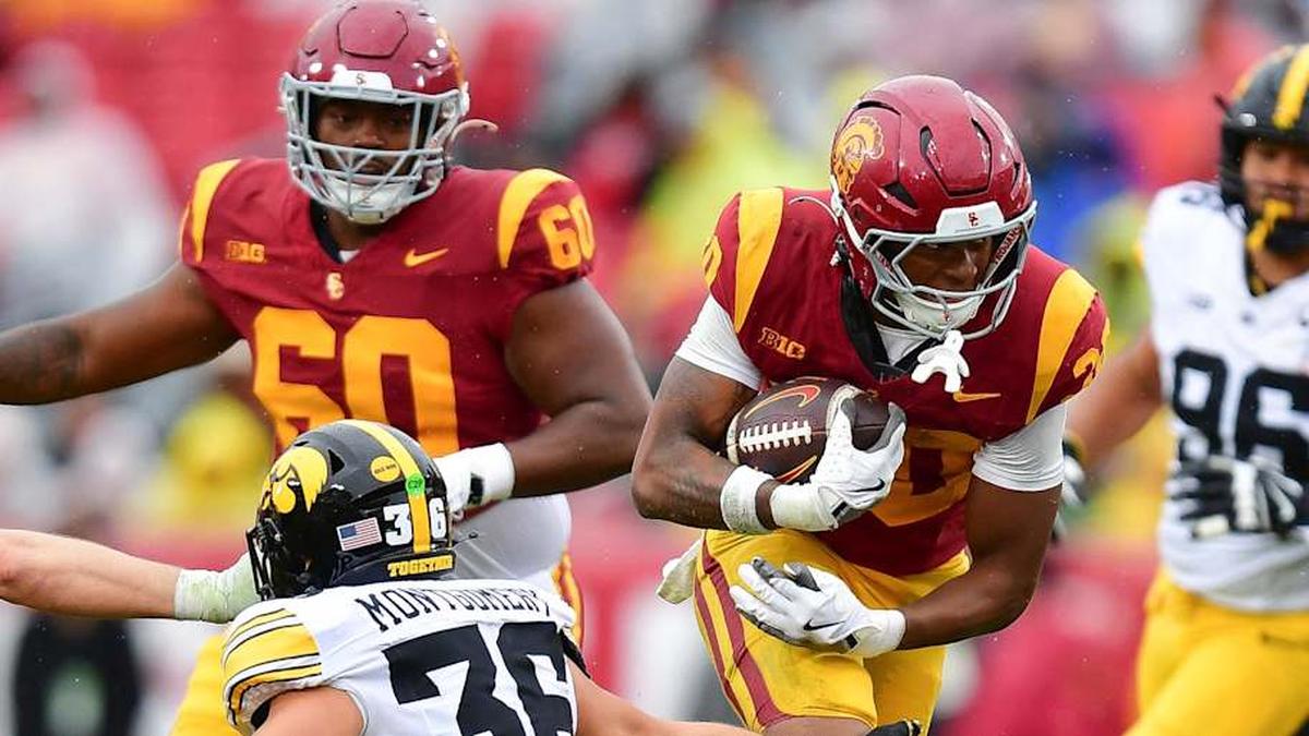  Nov 15, 2025; Los Angeles, California, USA; Southern California Trojans running back King Miller (30) runs the ball against Iowa Hawkeyes linebacker Jayden Montgomery (36) during the first half at the Los Angeles Memorial Coliseum. Mandatory Credit: Gary A. Vasquez-Imagn Images | Gary A. Vasquez-Imagn Images 