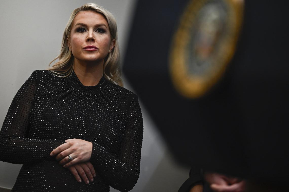 Karoline Leavitt listens to US President Donald Trump's press conference.