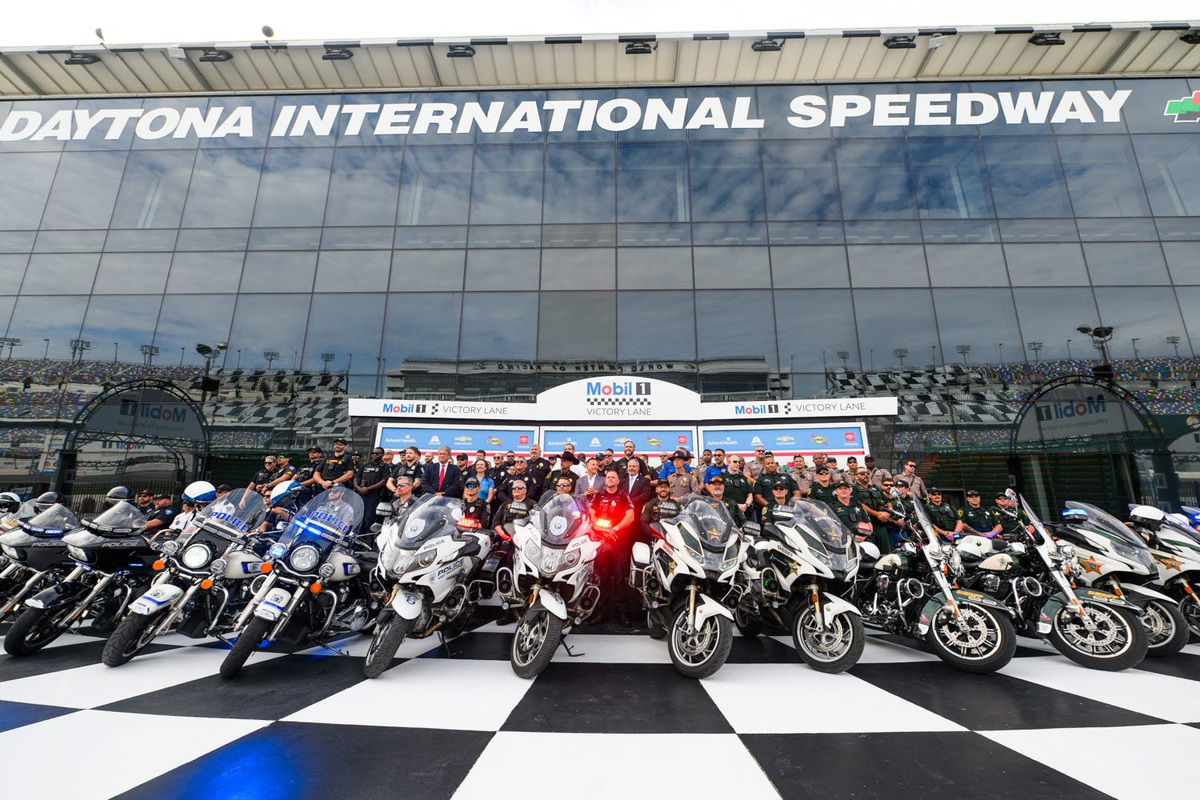 Officers and their motorcycles pose for a photo on Victory Lane before the announcement of Operation Southern Slow Down 2026, Monday, July 13, 2026, at the Daytona International Speedway.