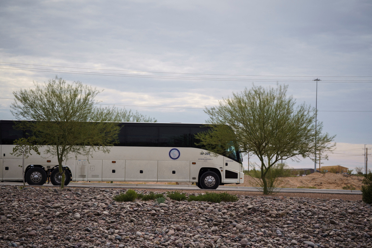 FILE PHOTO: A bus used to transport detainees of Immigration and Customs Enforcement exits Camp East Montana, the new ICE detention facility being built to house up to 5,000 migrants, which is under construction at Fort Bliss in El Paso, Texas, U.S., August 17, 2025.  REUTERS/Paul Ratje/File Photo