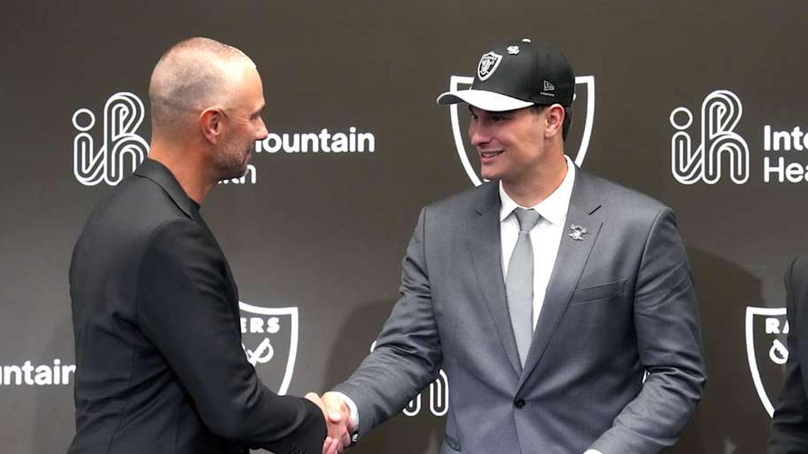  Apr 24, 2026; Henderson, NV, USA; Las Vegas Raiders quarterback Fernando Mendoza (right) shakes hands with general manager John Spytek at introductory press conference at Intermountain Healthcare Performance Center after being selected as the No. 1 pick in the 2026 NFL Draft. Mandatory Credit: Kirby Lee-Imagn Images | Kirby Lee-Imagn Images 