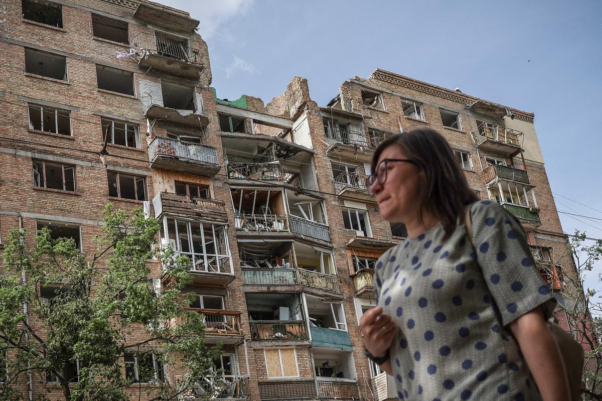 A woman passes by a damaged residential building, which was hit during yesterday’s Russian missile and drone attack, amid Russia's attack on Ukraine, in Kyiv, Ukraine, May 25, 2026. REUTERS/Alina Smutko