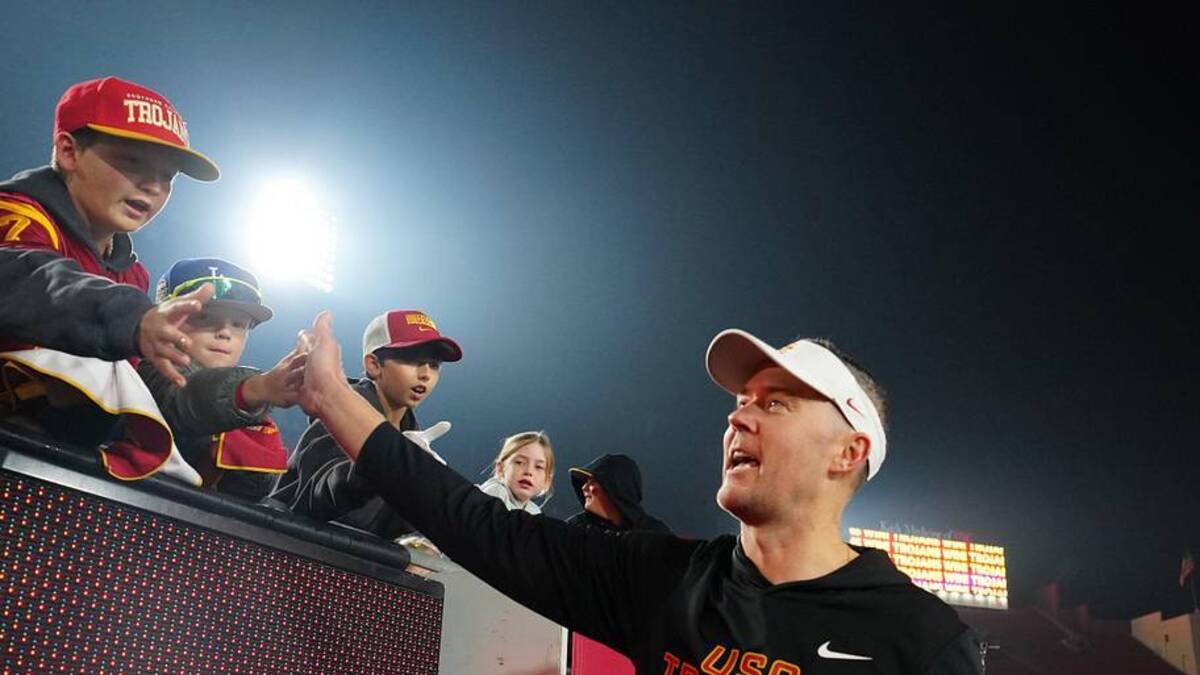  Nov 29, 2025; Los Angeles, California, USA; Southern California Trojans head coach Lincoln Riley celebrates with fans after the game against the UCLA Bruins at United Airlines Field at Los Angeles Memorial Coliseum. Mandatory Credit: Kirby Lee-Imagn Images | Kirby Lee-Imagn Images 