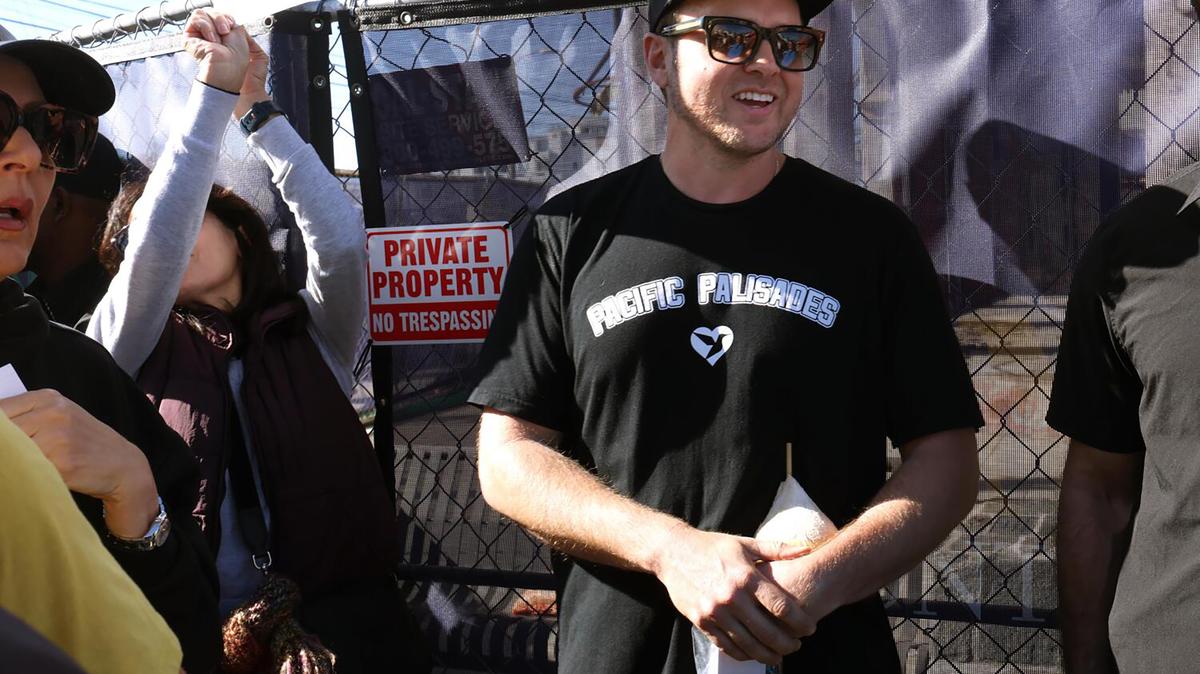 Palisades resident Spencer Pratt, who lost his home in the Palisades fire, stands with supporters after announcing his run for Los Angeles mayor on the one year anniversary of the Palisades fire in the Palisades Village on Jan. 7, 2026. Pratt is suing the City of Los Angeles and DWP for alleged mismanagement, while also publicly advocating for accountability from officials like California Governor Gavin Newsom regarding the Palisades fire, which destroyed thousands of homes in the tight-knit community. (Genaro Molina/Los Angeles Times/TNS)