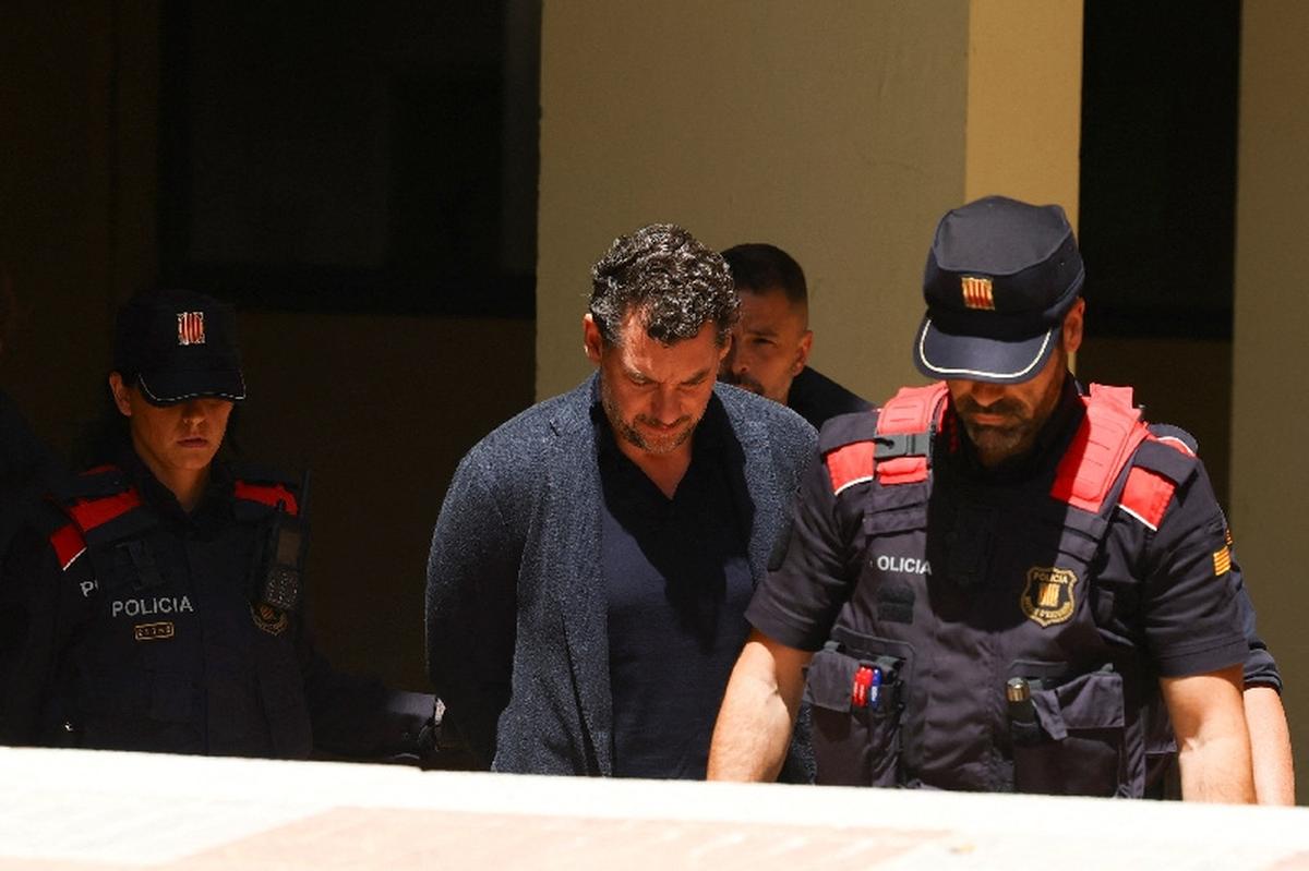 Jonathan Andic, the son of the founder of the Mango fashion group, Isak Andic, arrives at court escorted by police, where he is expected to be questioned after being detained in an investigation of the death of his father, who was killed in a fall from a cliff near Barcelona in December 2024, in Martorell, Spain, May 19, 2026. REUTERS/Albert Gea