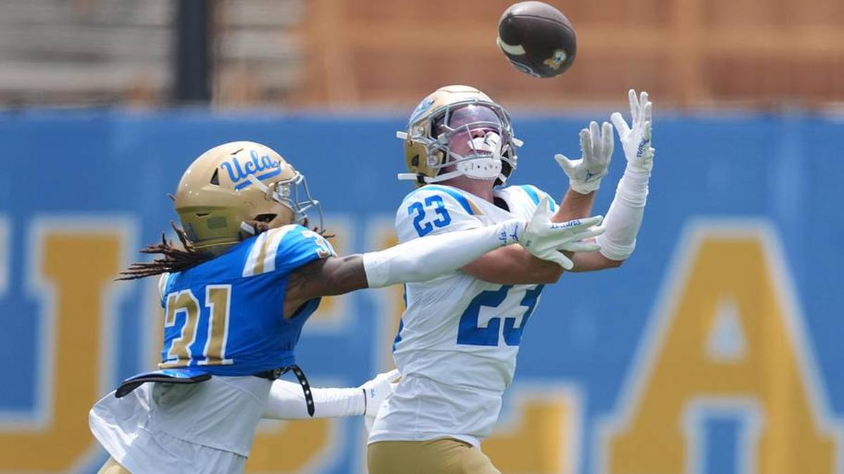  May 2, 2026; Pasadena, CA, USA; UCLA Bruins receiver Jackson Meehan (23) attempts to catch the ball against defensive back Chase Coleman (31) during the spring game at Rose Bowl. Mandatory Credit: Kirby Lee-Imagn Images | Kirby Lee-Imagn Images 