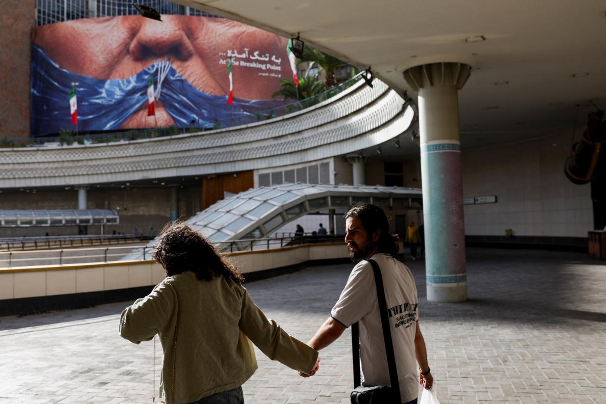 People walk past an anti-U.S. billboard depicting U.S. President Donald Trump and the Strait of Hormuz, in Tehran, Iran, May 17, 2026. Majid Asgaripour/WANA (West Asia News Agency) via REUTERS ATTENTION EDITORS - THIS PICTURE WAS PROVIDED BY A THIRD PARTY