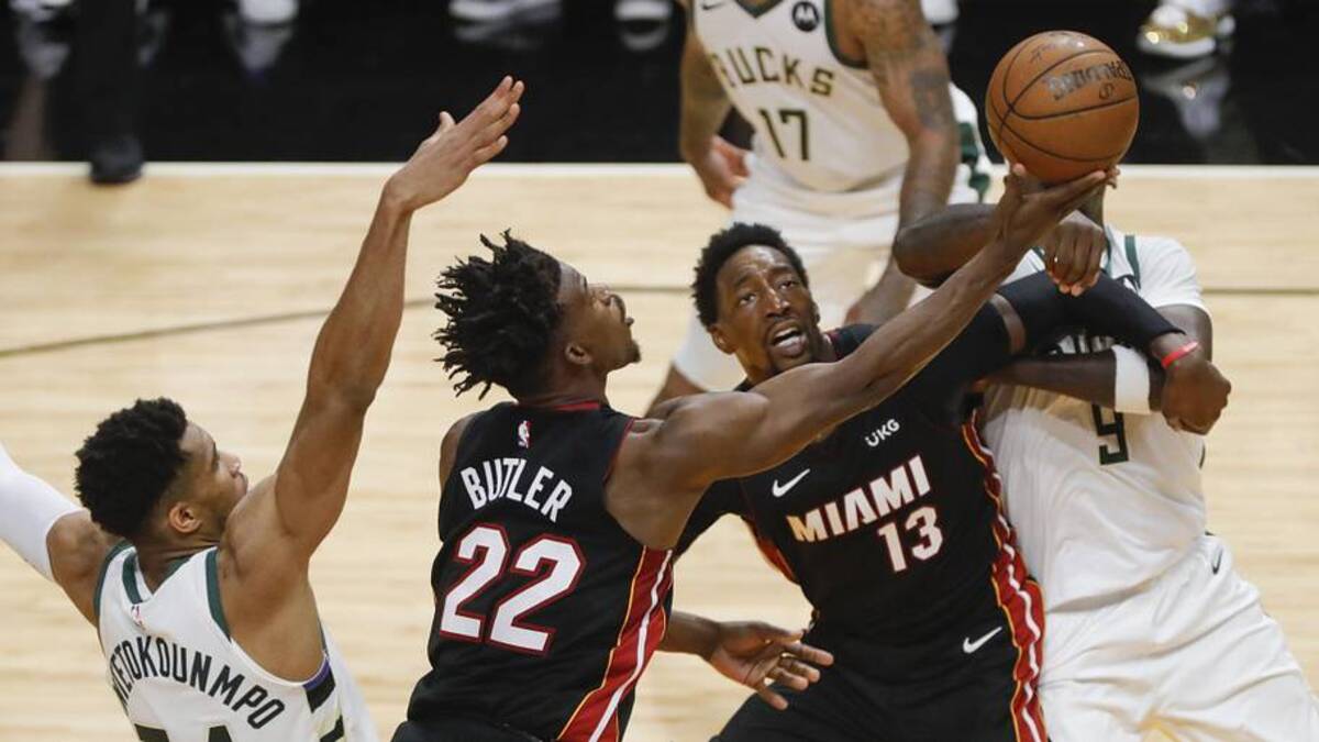 May 29, 2021; Miami, Florida, USA; Miami Heat forward Jimmy Butler (22) shoots the ball over Milwaukee Bucks forward Giannis Antetokounmpo (34) and Miami center Bam Adebayo (13) and Milwaukee center Bobby Portis (9) during the second quarter of game four in the first round of the 2021 NBA Playoffs at American Airlines Arena. Mandatory Credit: Sam Navarro-Imagn Images | Sam Navarro-Imagn Images 