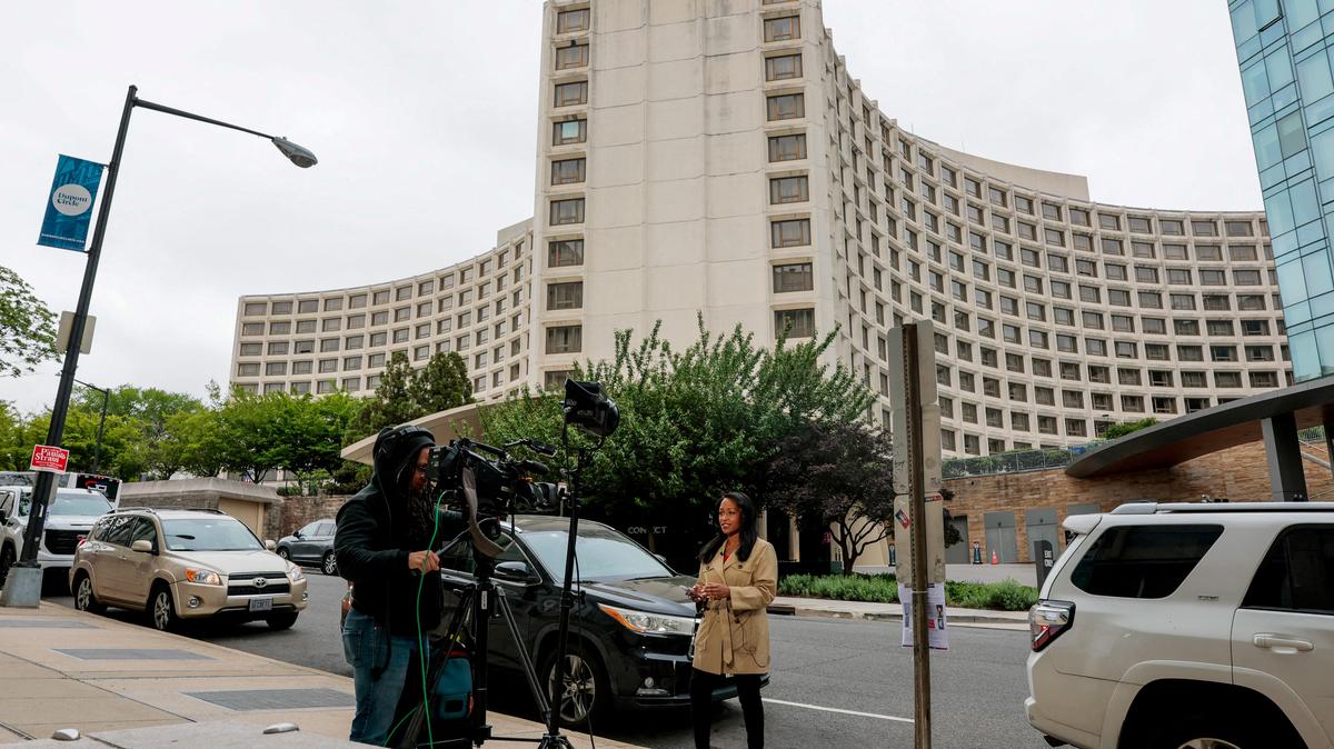 FILE PHOTO: Members of the media work near the Washington Hilton hotel, where a shooting incident at the annual White House Correspondents' Association dinner, in Washington, D.C., U.S., April 26, 2026. REUTERS/Kylie Cooper/File Photo