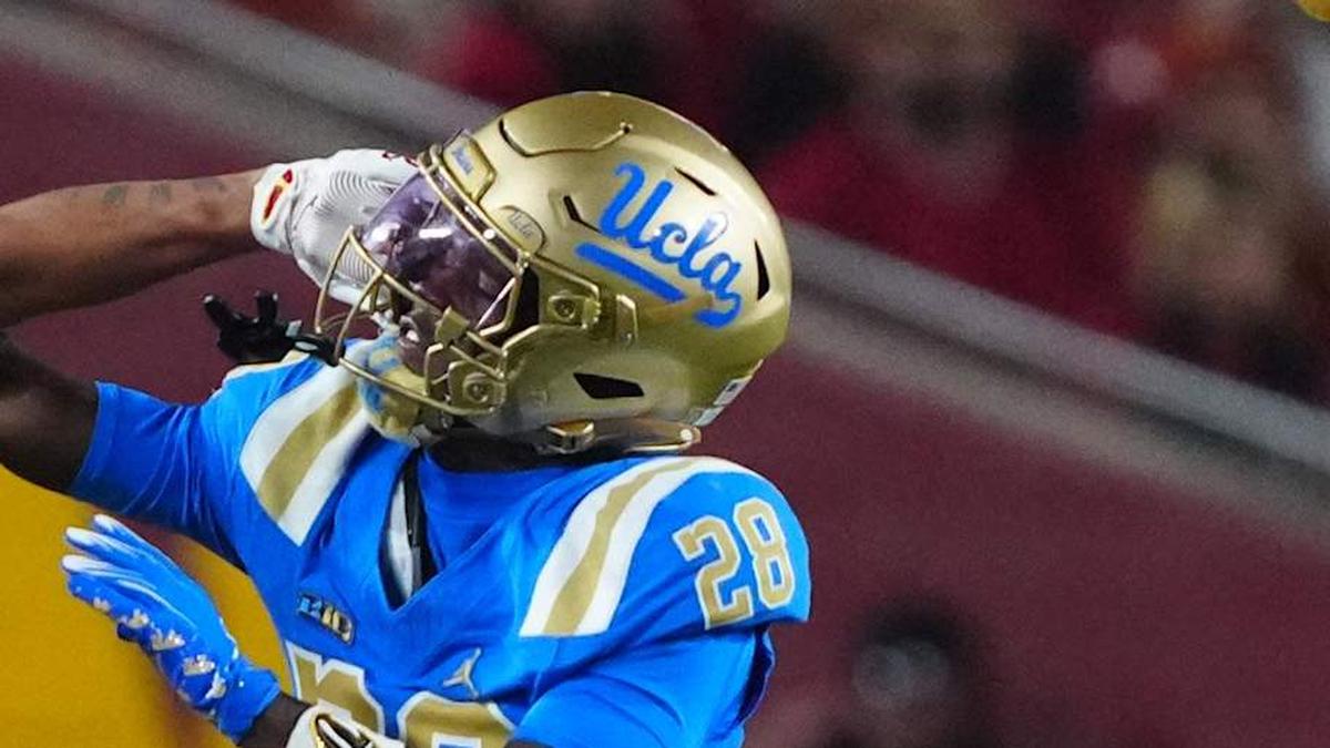  Nov 29, 2025; Los Angeles, California, USA; Southern California Trojans wide receiver Tanook Hines (16) carries the ball against UCLA Bruins defensive back Scooter Jackson (28) in the first half at United Airlines Field at Los Angeles Memorial Coliseum. Mandatory Credit: Kirby Lee-Imagn Images | Kirby Lee-Imagn Images 