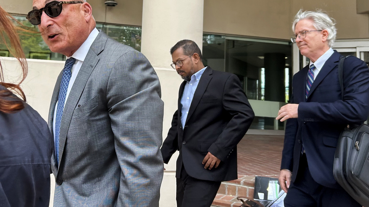 Karthikeyan Deenadayalan, center, leaves the U.S. District Court in Baltimore with his attorneys on Thursday, June 18, 2026. Deenadayalan, the chief engineer of the cargo ship Dali, is charged with violating the Port and Waterways Safety Act in connection with the Francis Scott Key Bridge collapse. (Maggie Trovato/The Baltimore Sun/TNS)