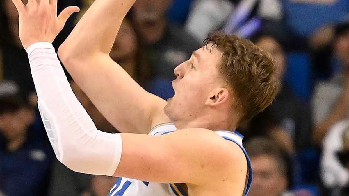  Feb 21, 2026; Los Angeles, California, USA; UCLA forward Tyler Bilodeau (34) shoots over Illinois guard Kylan Boswell (4) and Illinois center Zvonimir Ivisic (44) during overtime at Pauley Pavilion presented by Wescom Financial. Mandatory Credit: Robert Hanashiro-Imagn Images | Robert Hanashiro-Imagn Images 