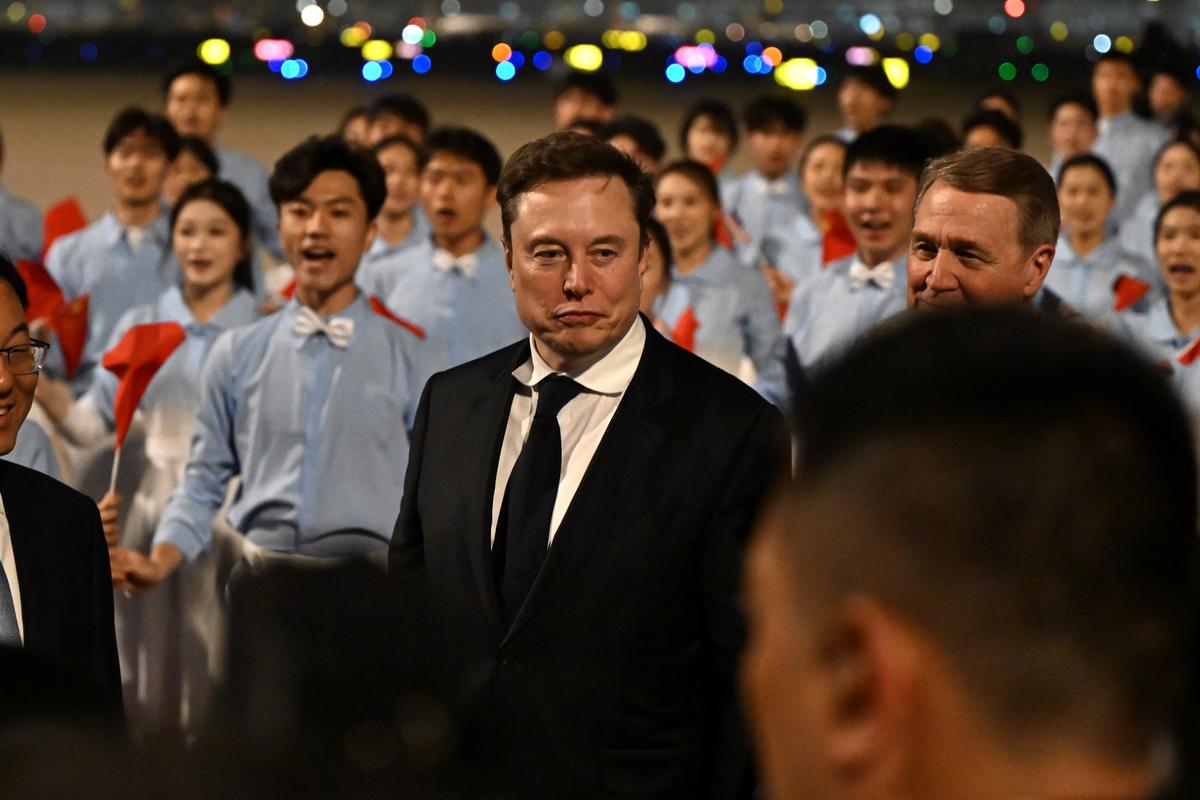 Elon Musk, one of the business executives accompanying President Donald Trump, arrives at Beijing Capital International Airport in Beijing, China, on Wednesday, May 13, 2026. Trump is scheduled to hold a two-day summit with China's leader, Xi Jinping. (Kenny Holston/The New York Times)