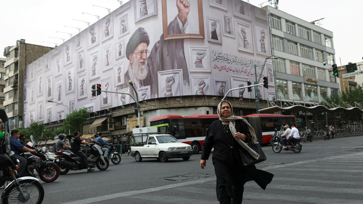 A woman walks near a billboard with an image of the late Iranian Supreme Leader Ayatollah Ali Khamenei, in Tehran, Iran, May 19, 2026. Majid Asgaripour/WANA (West Asia News Agency) via REUTERS