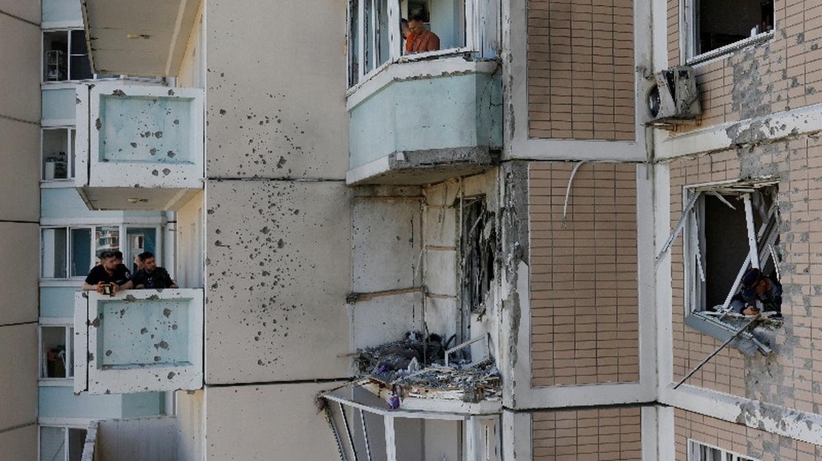 Residents clear debris from broken windows in a damaged apartment building following a Ukrainian drone attack in the course of Russia-Ukraine conflict in Krasnogorsk, in the Moscow region, Russia May 17, 2026. REUTERS/Stringer