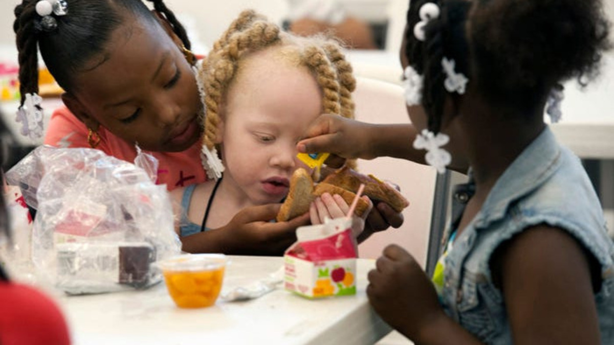Yazmonea Griffin, left, and Yurantianna Kent, right, helps Saraih Martin, center; prepare her lunch at the Ebonwood Community Center on June 2, 2015. The meals were provided to the center through the Bay Area Food Bank and its summer food program.