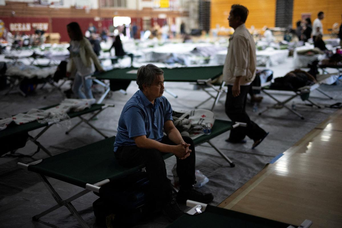 Viwath Taing, 51, who evacuated from Garden Grove, sits on a cot at Ocean View High School Gymnasium, which has been turned into a temporary shelter after residents were evacuated following an evacuation order prompted by a failing tank containing methyl methacrylate, a flammable liquid used in the aerospace industry, in Huntington Beach, California, U.S., May 23, 2026. REUTERS/Ed Ou