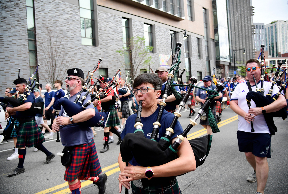 Soccer Football - FIFA World Cup 2026 - Scotland's Tartan Army march to Boston's Fenway Park baseball stadium - Boston, Massachusetts, U.S. - June 14, 2026 Scotland fans wearing kilts and playing the bagpipes during the march to Fenway Park IMAGN IMAGES via Reuters/Bob Dechiara